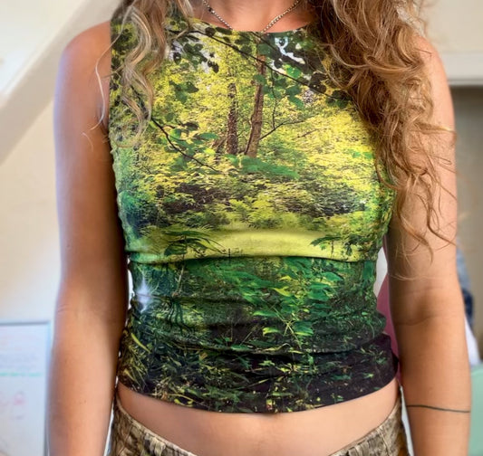 Tank top featuring photograph of a clearing in a bright green forest.