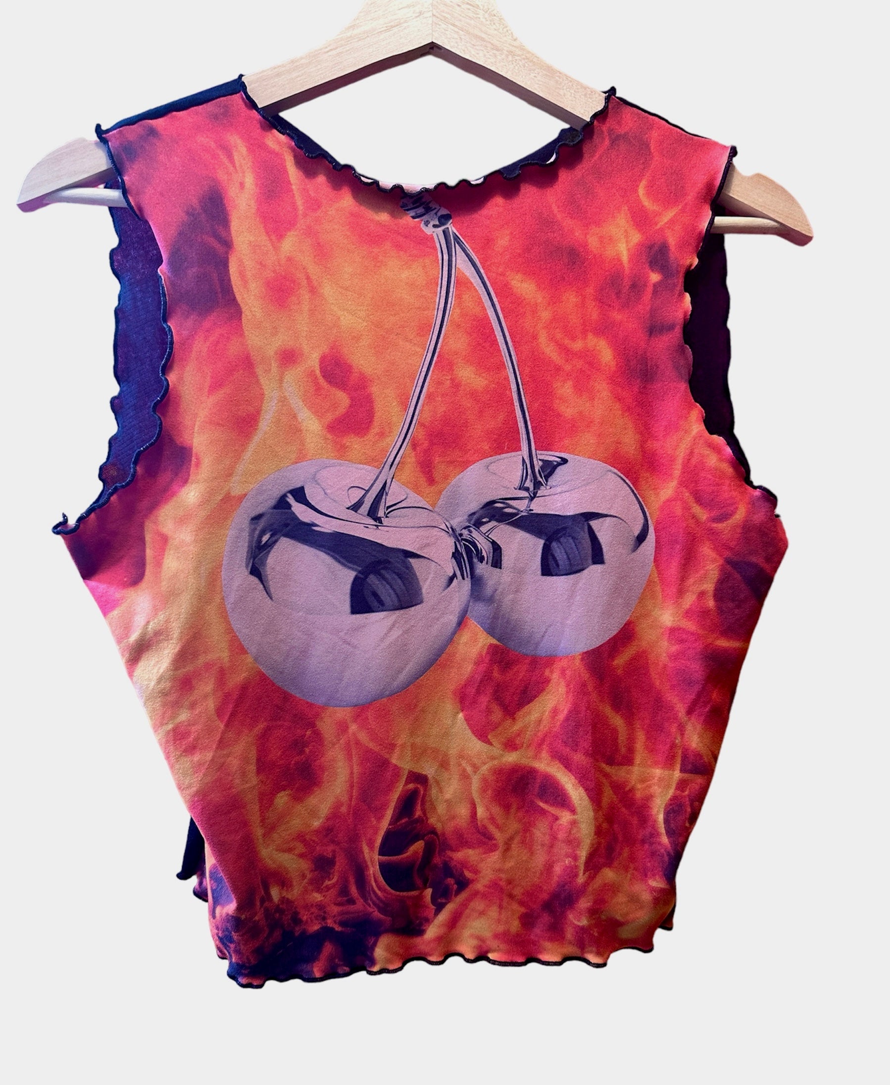Tank top with chrome cherries set against flame backgrounde.